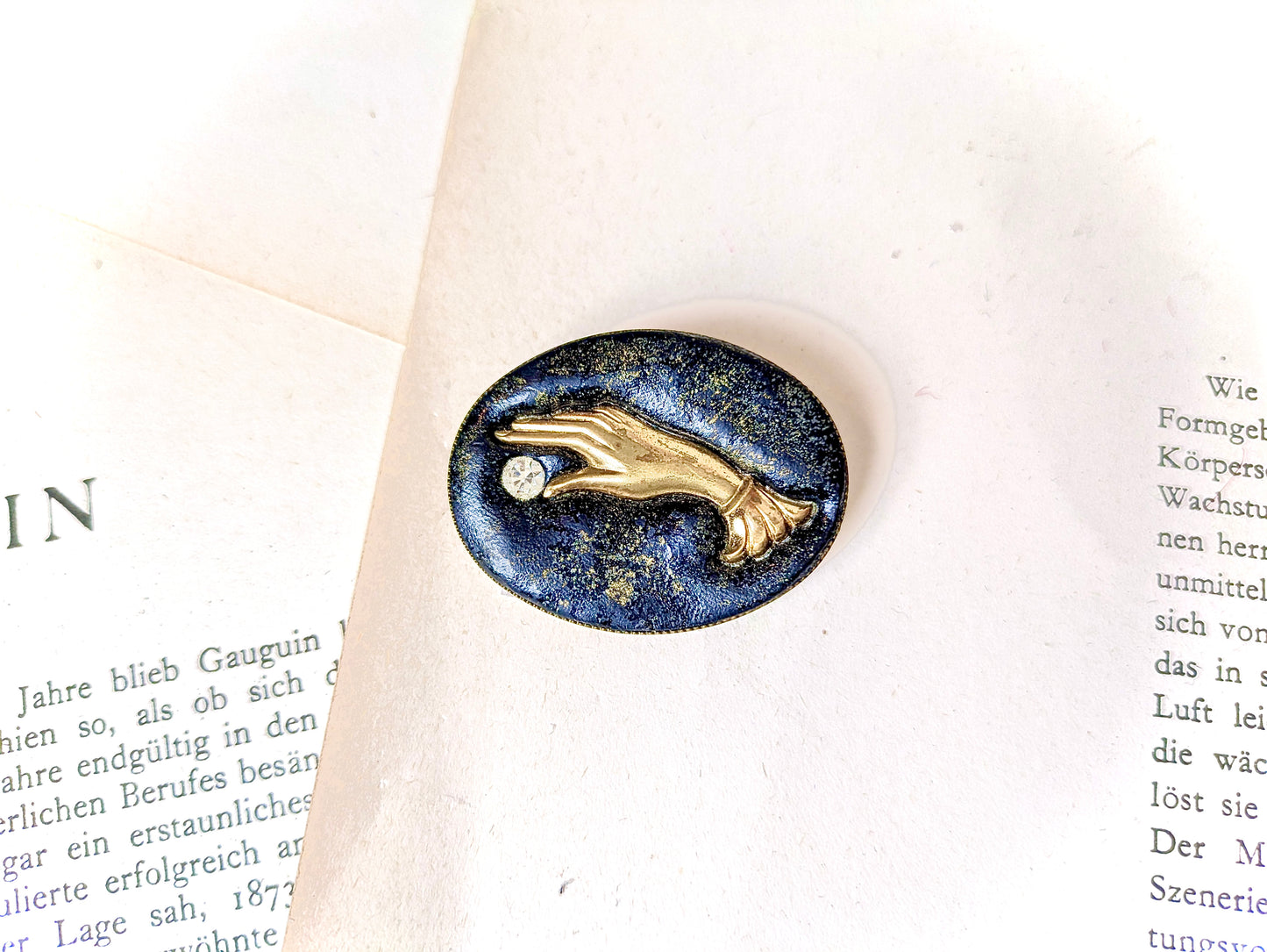 brooch with hand