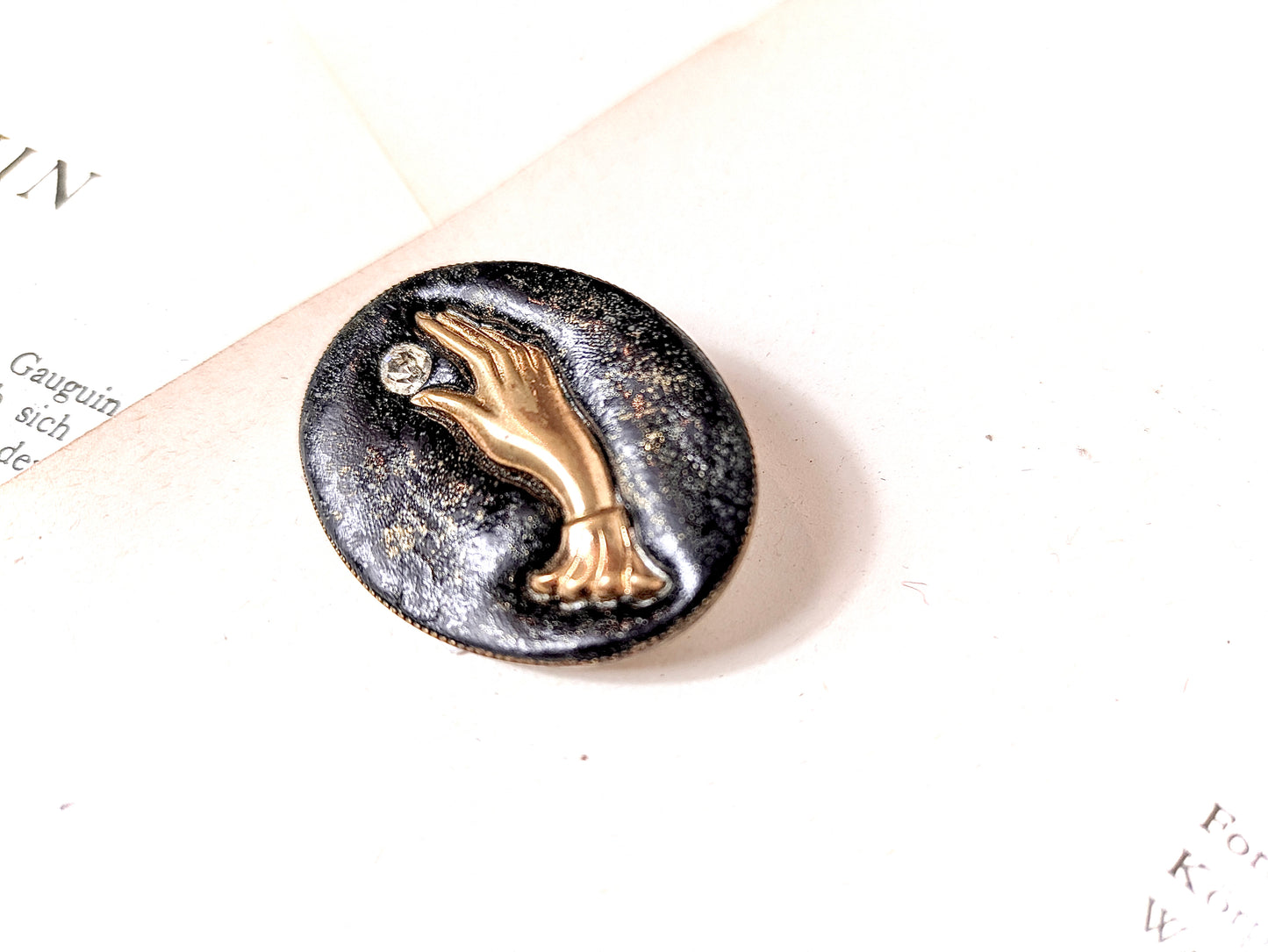 brooch with hand