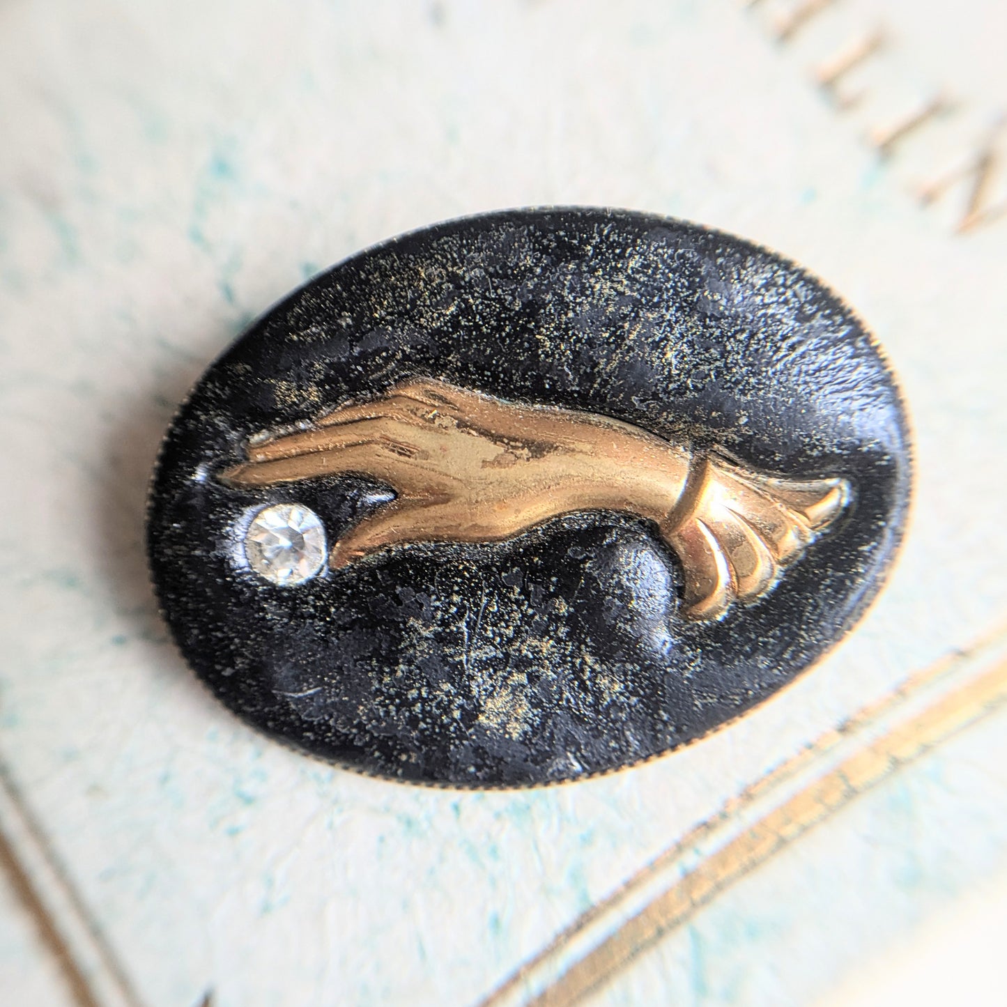 brooch with hand